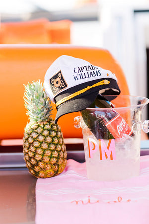 Clear ice bucket with 'PM' initials in pink and orange