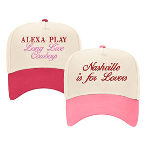 Set of two custom cream-colored trucker hats featuring playful designs. One hat has 'Alexa Play Long Live Cowgirls' in bold red and pink text, while the other reads 'Nashville is for Lovers' in elegant red script. Perfect for adding personality to casual outfits.