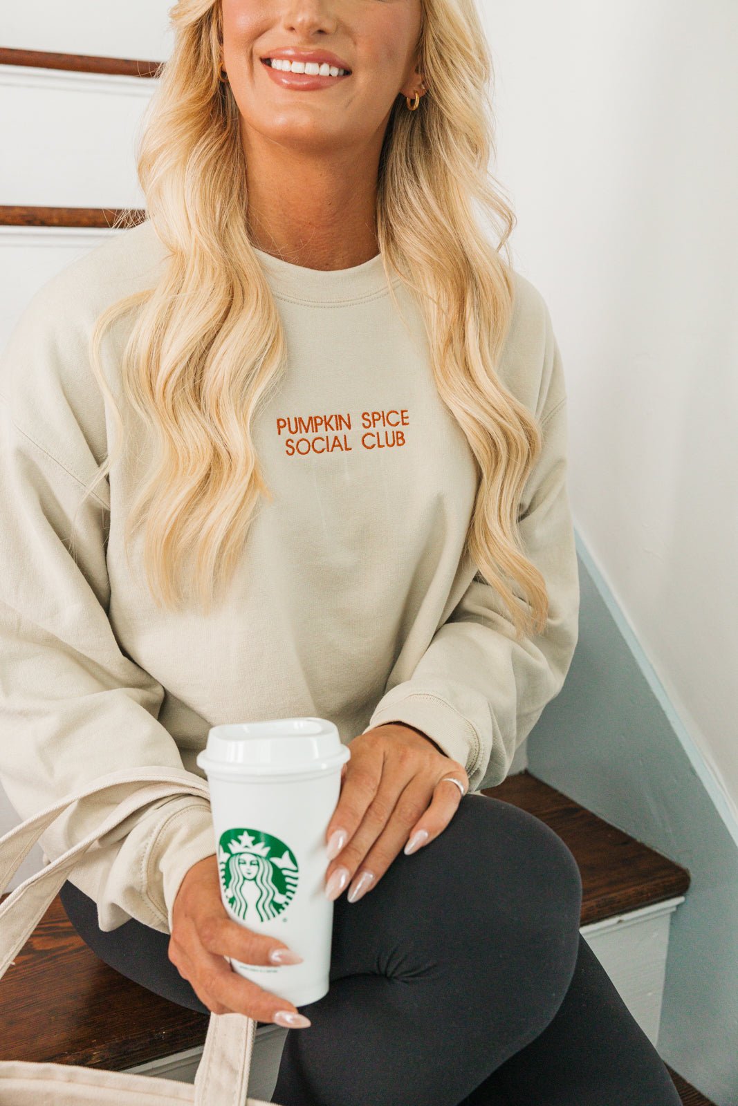 Two custom embroidered sweatshirts displayed against a white background. The first sweatshirt is beige with the text 'Espresso Martini' in brown embroidery, and the second sweatshirt is white with the text 'Marriage Material' in light blue embroidery.