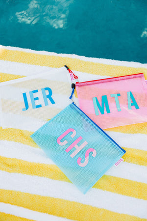 A group of pool bags are customized with two color monograms.