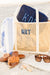 A canning tote is customized with a navy blue monogram