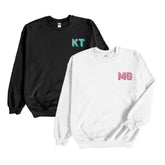 A black and a white sweatshirt are customized with embroidered monograms on the left chest