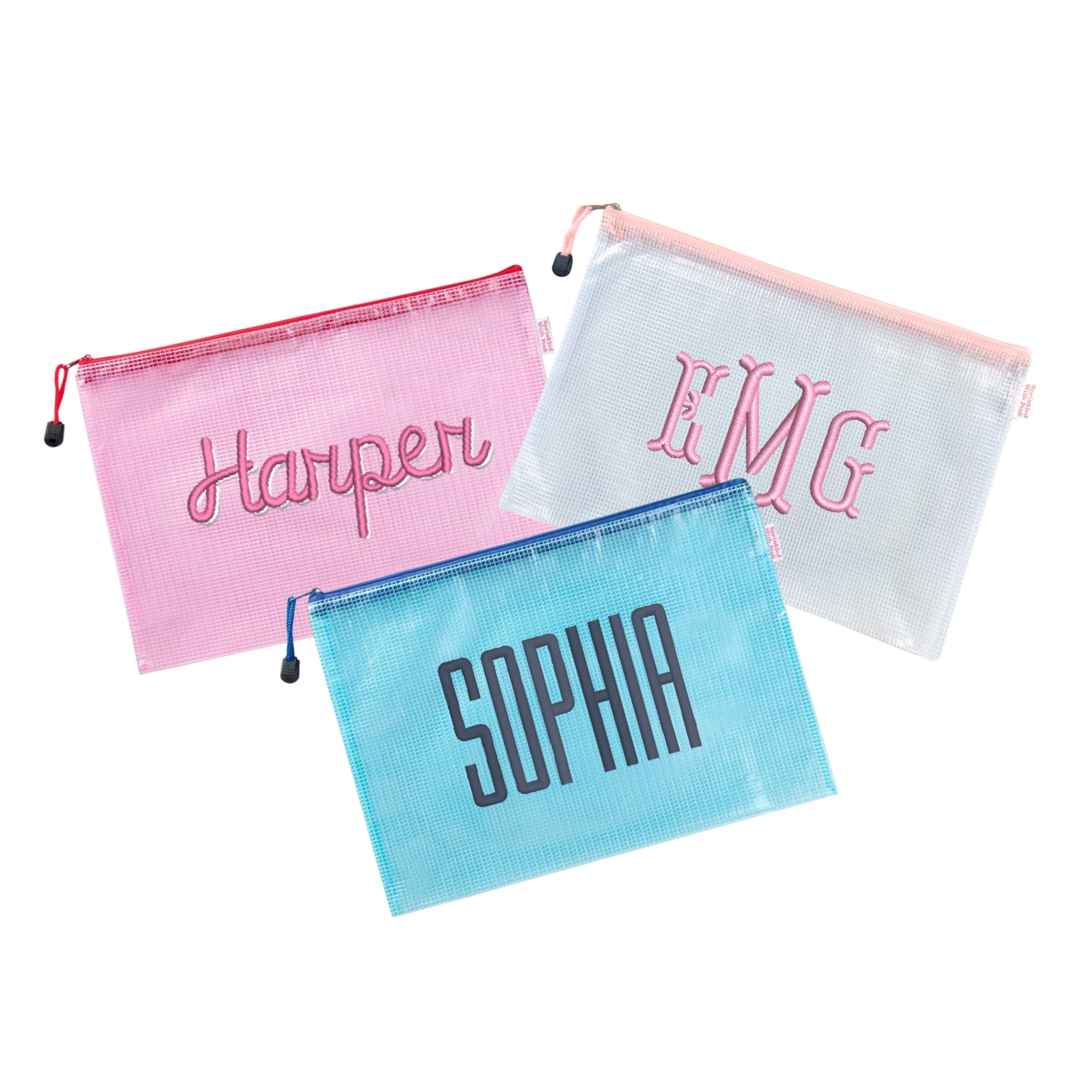 Three custom embroidered mesh pouches displayed against a white background. The first pouch is pink with the name 'Harper' in script embroidery, the second pouch is white with the monogram 'EMG' in pink embroidery, and the third pouch is blue with the name 'Sophia' in block embroidery.