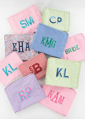 An assortment of gingham roadies are customized with monograms in different colors.