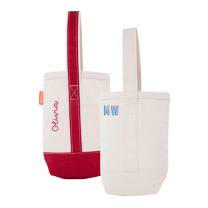 Personalized mini canvas tote set featuring two designs: one with 'Olivia' embroidered in pink and accented with a bold red base and handle, and another with 'MW' monogrammed in light blue on a neutral cream background. These versatile and stylish totes are perfect for carrying small essentials.