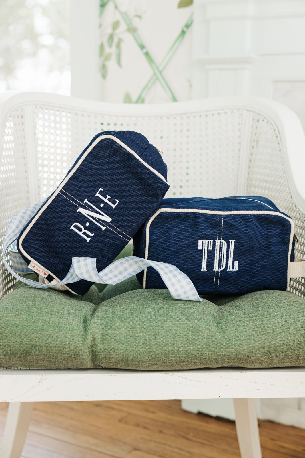 A navy Personalized Canvas Travel Dopp Kit from Sprinkled with Pink, featuring a monogrammed "NDW" in elegant embroidery. Designed for both style and functionality, this durable canvas toiletry bag is accented with white piping and a sturdy zipper closure, making it the perfect addition to a custom travel essentials set. Ideal for gifting or personal use, this monogrammed dopp kit is great for organizing grooming products, cosmetics, and travel necessities in a stylish and practical way.