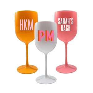 A group of acrylic wine glasses are customized with monograms and custom wording