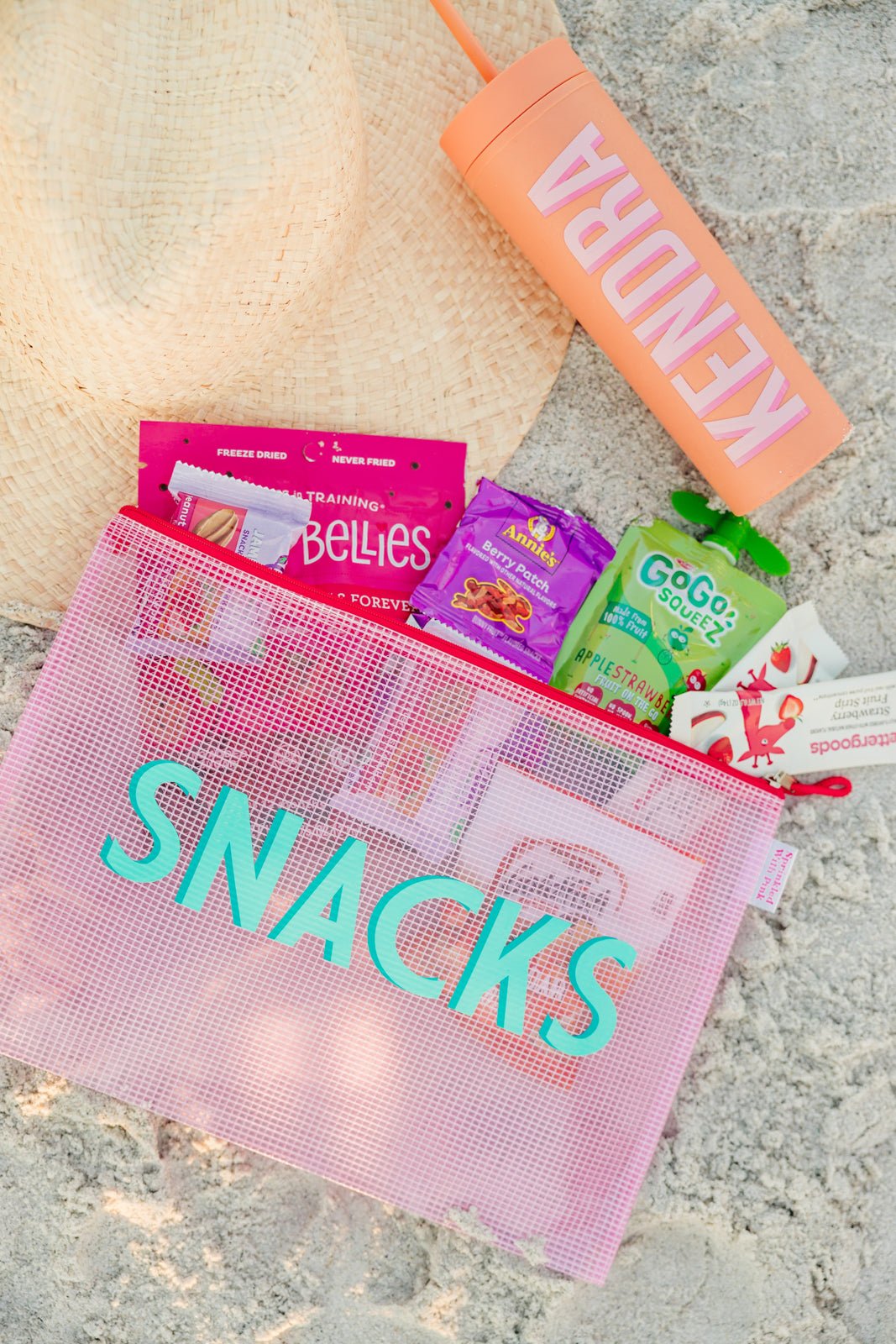 A group of pink, blue and white pool bags are customized with colorful monograms.