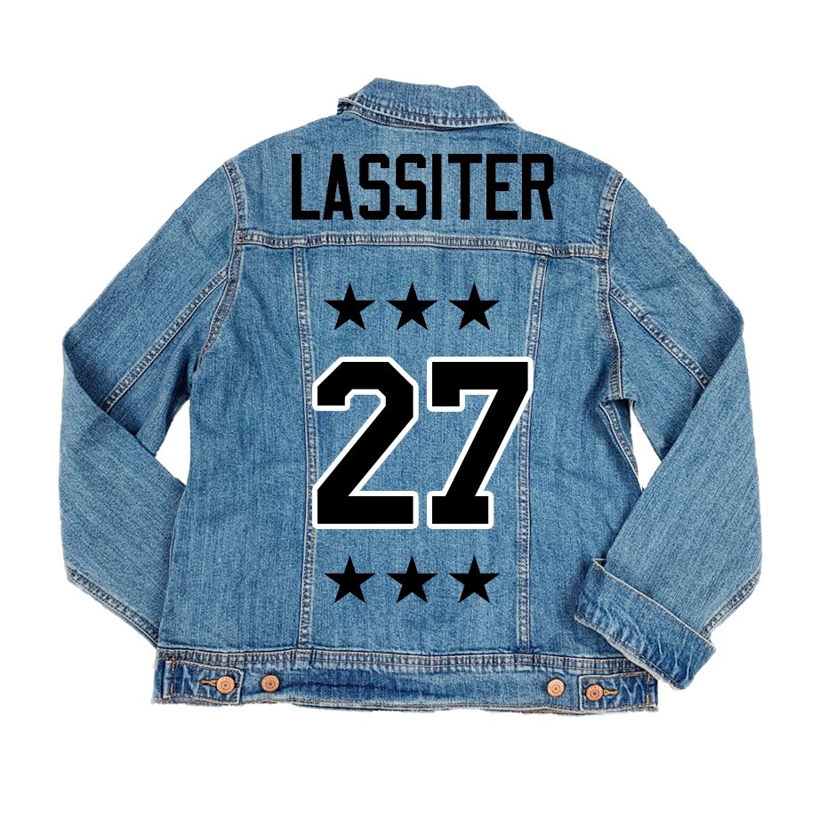 A denim jacket is customized with a red design featuring a custom number and last name.