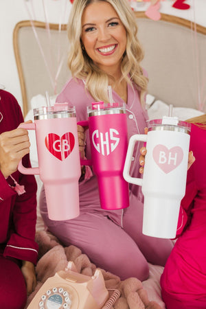 A group of girls cheers with their customized Valentine's Day tumblers