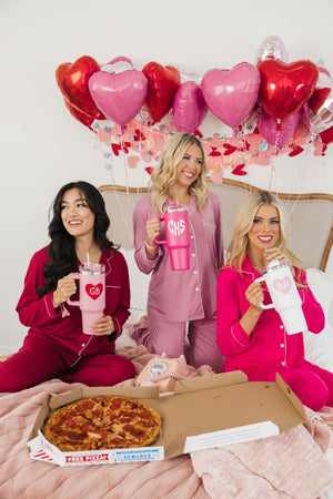 A group of girls cheers with their customized Valentine's Day tumblers