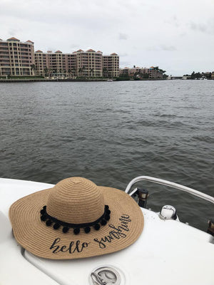 A hat sits on a boat and reads "hello sunshine"