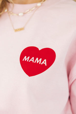 A pink sweatshirt is decorated with a red heart that reads "Mama"