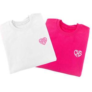 Sweatshirts are laid out to show off their custom heart monogram which is embroidered on the chest.