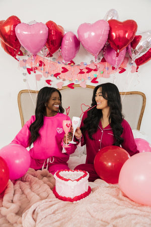 Two girls are seen celebrating Valentine's Day with their custom embroidered sweatshirts.