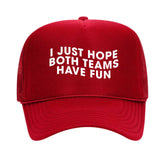 A red trucker hat from our gameday collection that reads "I Just Hope Both Teams Have Fun" on a white background.