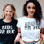 A bride and her friends wear matching bachelorette shirts which say "Bride or Die" and bandanas.